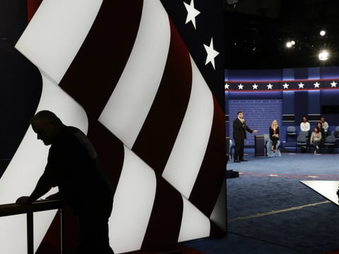 Students stand in on the stage as preparations are made for the second presidential debate at Washington University in St. Louis.
